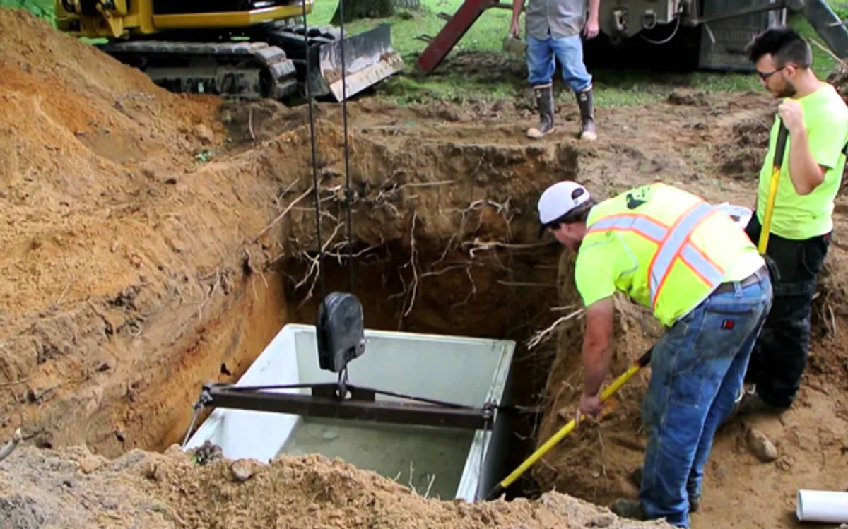 Heavy excavator preparing a residential site for foundation protection and drainage system installation in Austin, TX